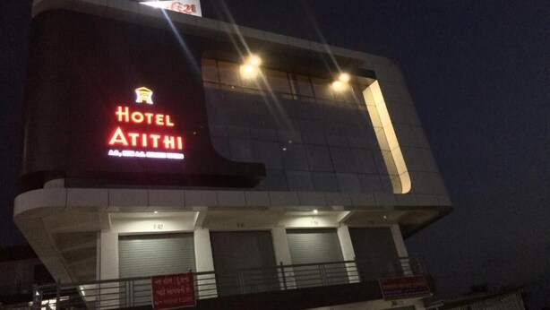 A modern hotel building with a prominent sign reading "Hotel Atithi." - Hotel Atithi (Mahesana)