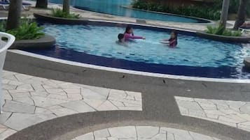 Outdoor pool, open 7:00 AM to 10:00 PM, pool umbrellas