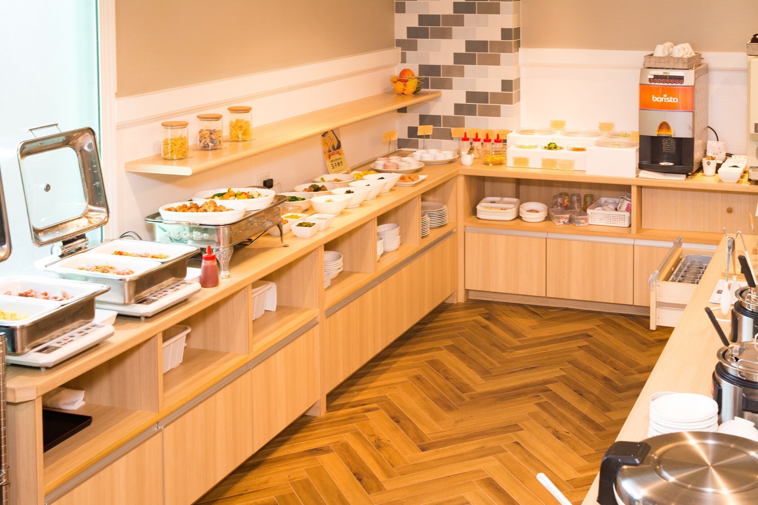 A buffet setup with various food items and a coffee machine.