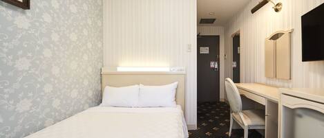 A hotel room with a bed, a desk, a chair, a television, and a mirror.