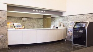 A reception area with a marble counter, a cash register, and a self-service kiosk. - Business Inn Norte 2 (Sapporo)