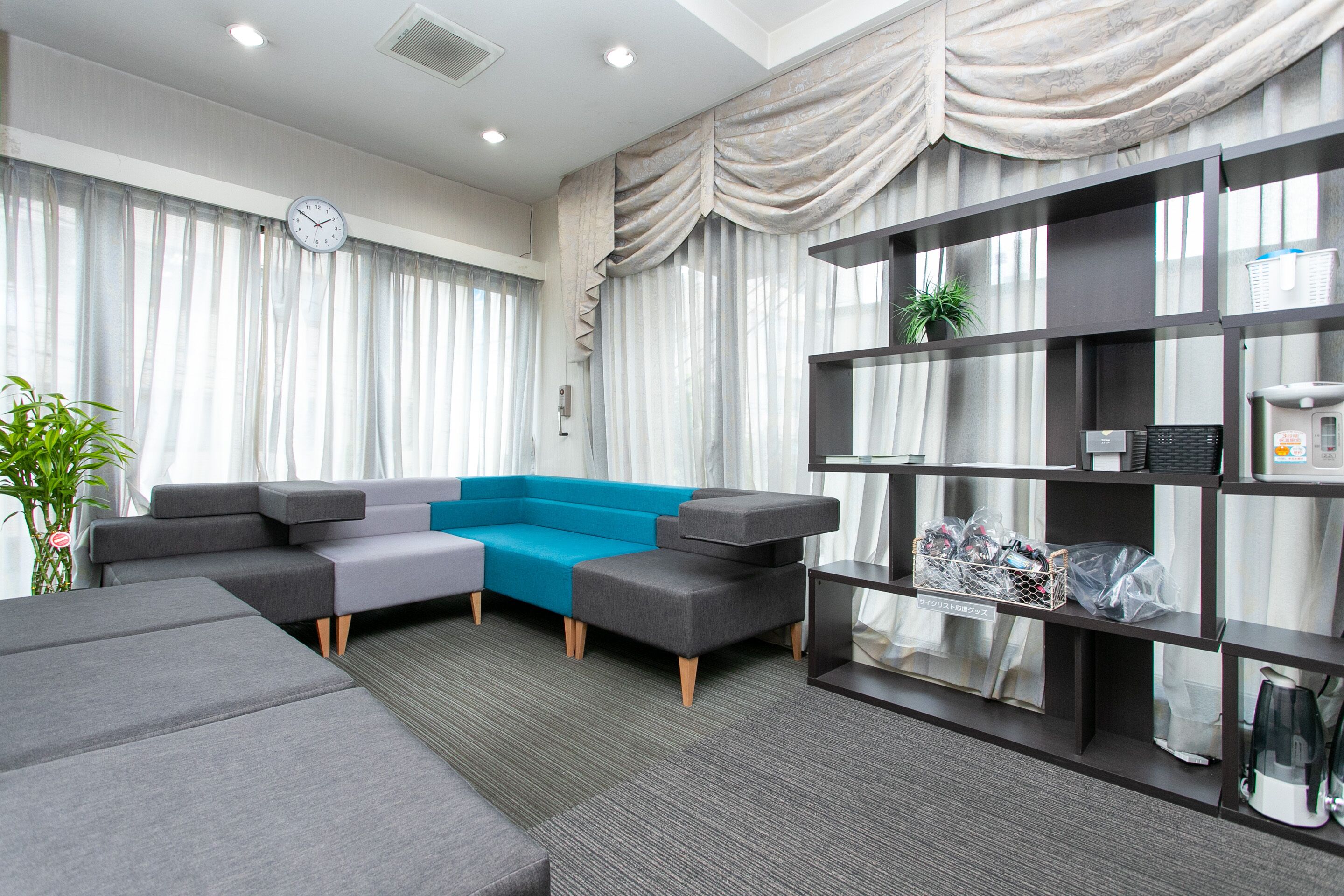 A modern living room with a sectional sofa, a coffee table, and a built-in bookshelf.