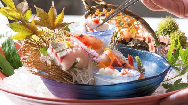 A seafood dish with various ingredients and garnishes.