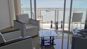 Deluxe Apartment, 1 Bedroom, Sea View | Living room | Flat-screen TV