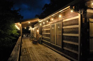 A wooden building with large windows and a covered porch. - Breezy Bear Spacious Cabin, Lrg Kitchen - Free Pool Access (Sevierville)