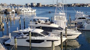 A marina with several yachts docked at wooden piers. - Great location, few steps from the beach!!! (Miramar Beach)