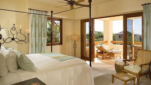 A bedroom with a four-poster bed, a nightstand, and a chair. - Esperanza Resort, PRIVATE POOL, JACUZZI PLUS 4 Bedroom, 4 1/2 Bath (Cabo San Lucas)