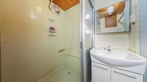 A bathroom with a shower, a sink, and a mirror. - Mizusawa Green Hotel (Oshu)