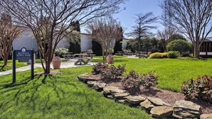 A park with picnic tables, a sign indicating it's a wireless-enabled no-smoking area, and a well-maintained lawn. - Walk to Bethany Beach Boardwalk: Coastal Retreat (Bethany Beach)