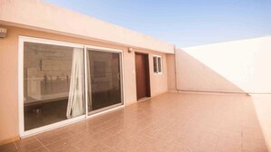 A building with a large sliding glass door, a small door, and a window. - DEPARTMENT FOR 5 PEOPLE. EXCELLENT LOCATION (Playa del Carmen)