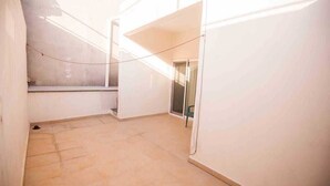 A narrow, enclosed space with tiled flooring and white walls. - DEPARTMENT FOR 5 PEOPLE. EXCELLENT LOCATION (Playa del Carmen)