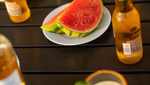A dining table with various food items and drinks. - Avalon 2 Unit Buyout (II & IV) by AvantStay | Mins to Gaslamp! Patio w/ BQQ (San Diego)