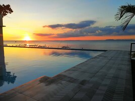 Una piscina al aire libre, sillones reclinables de piscina