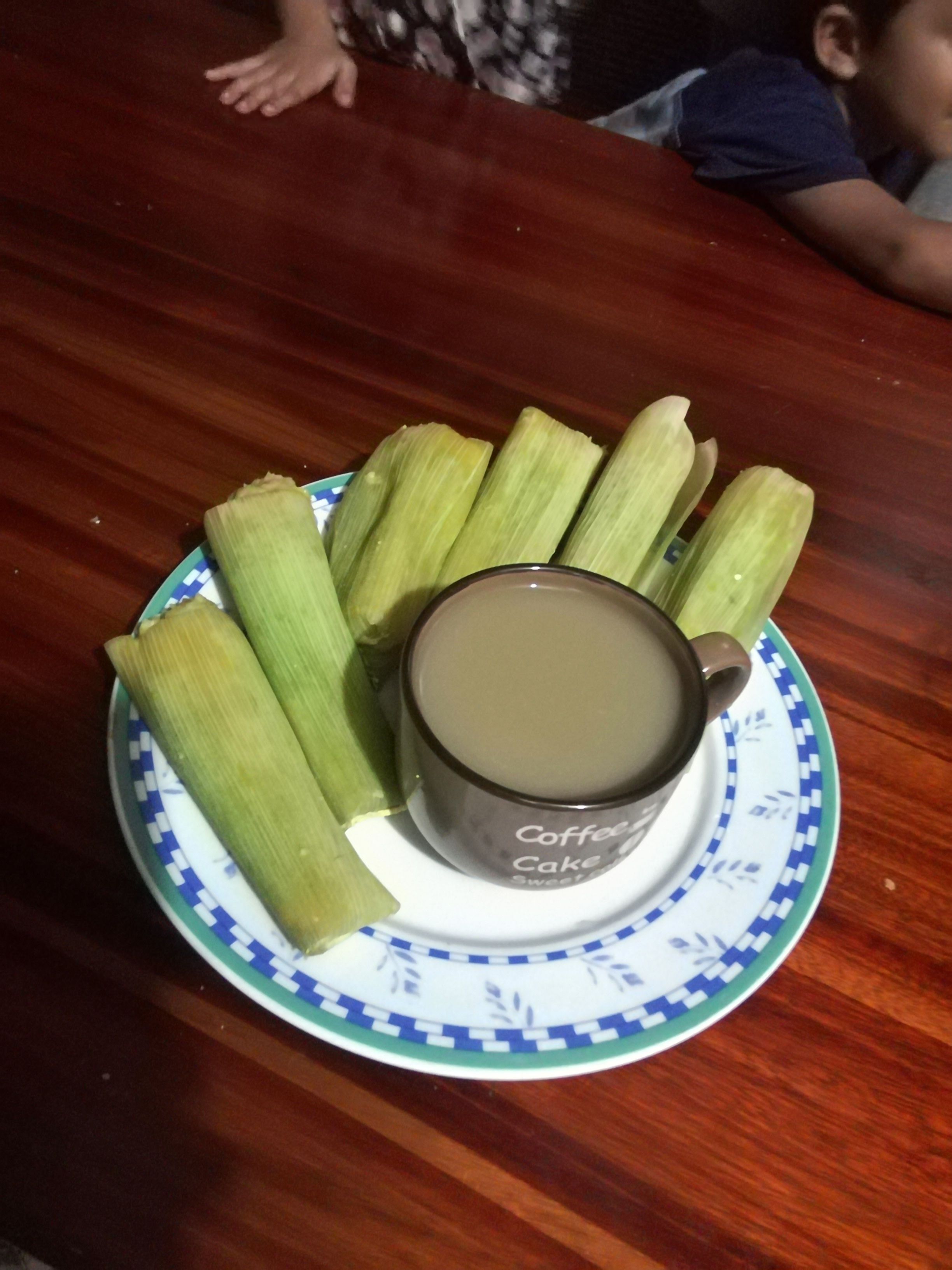 Ein Teller mit Tamales und einer Tasse, beschriftet mit 'Coffee Cake Sweet'.