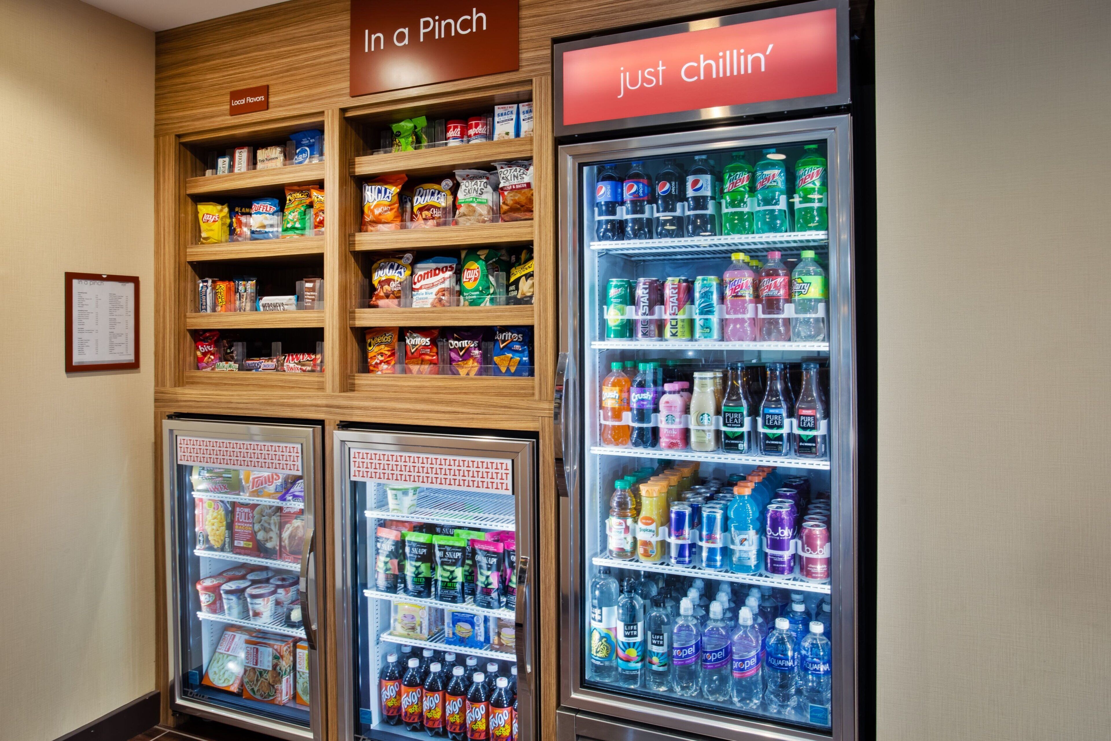 A vending area with snacks and drinks, including chips, candy, and various sodas.
