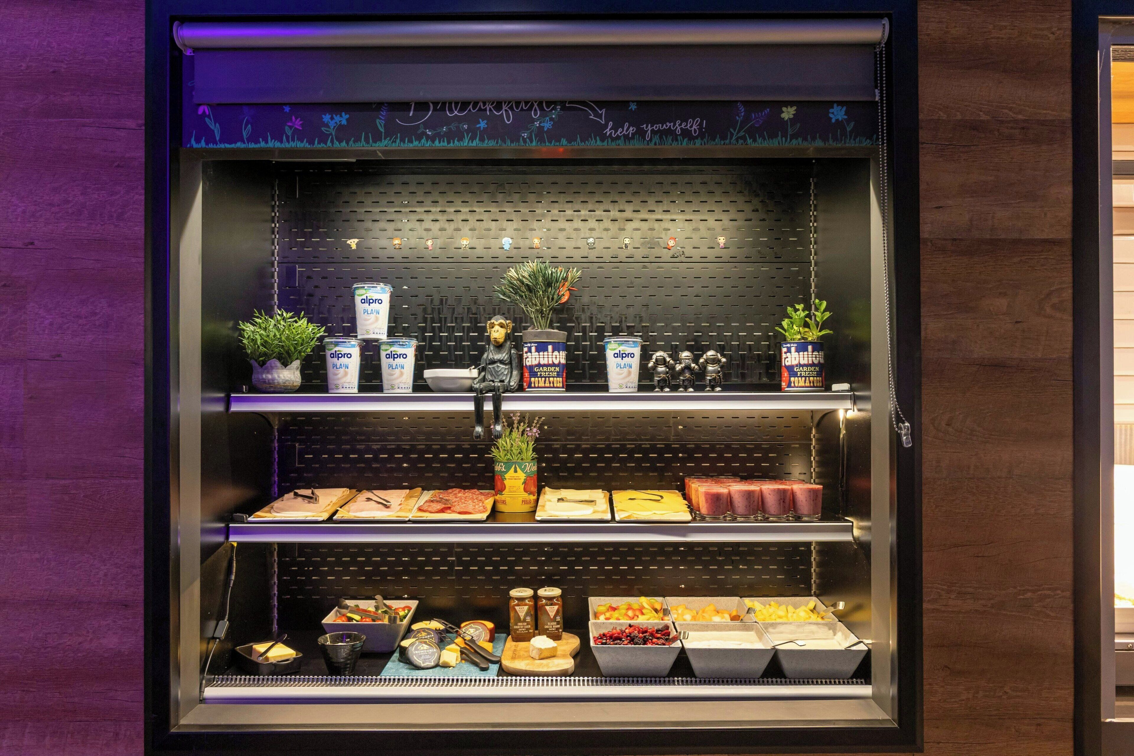 A display case with various food items and plants.