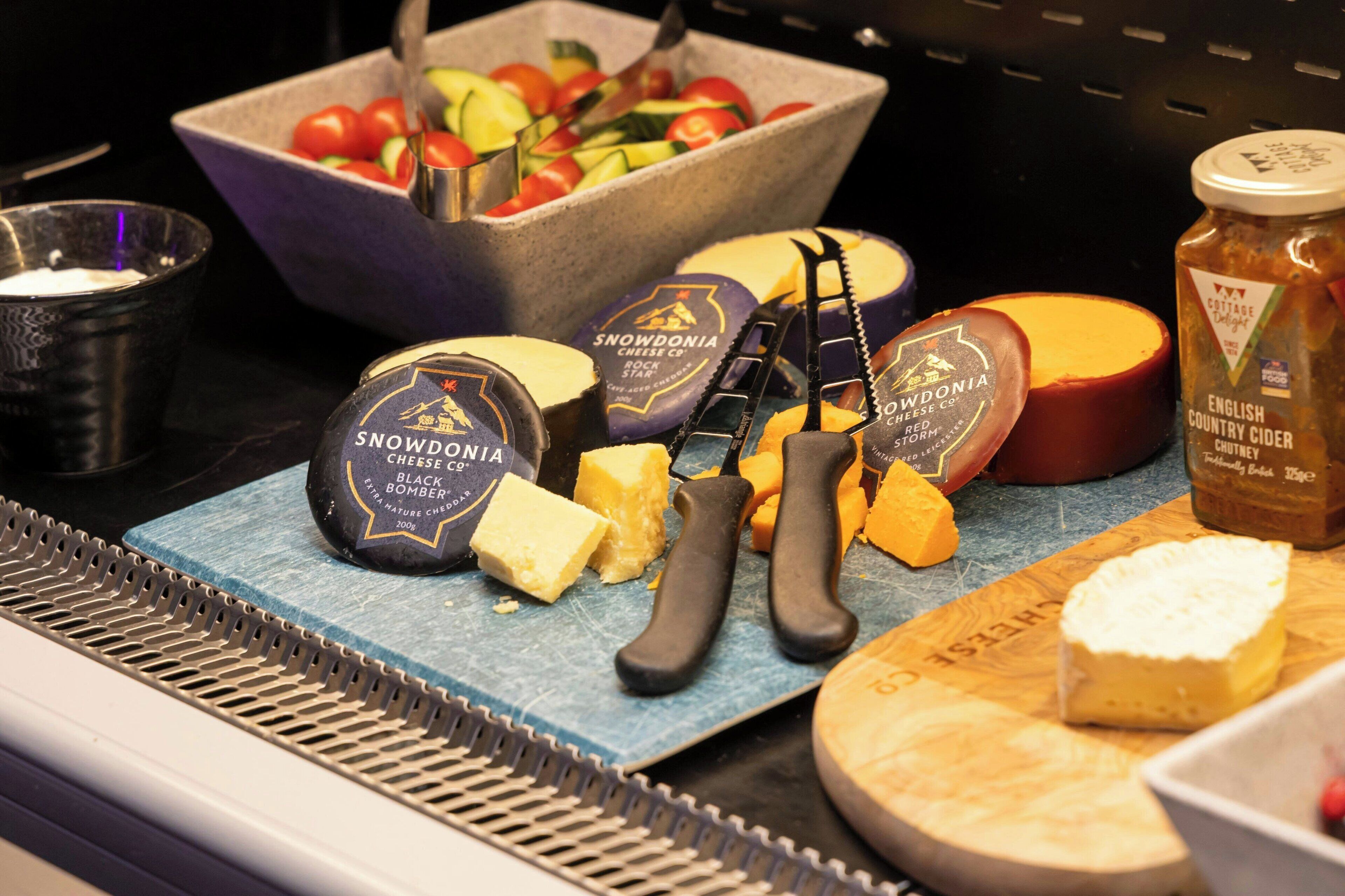 A cheese and cheese knife display with Snowdonia cheese and English country cider.
