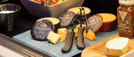 A cheese and cheese knife display with Snowdonia cheese and English country cider.