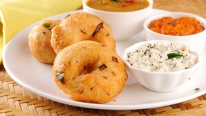 A plate with three fried snacks, a bowl of soup, and two side dishes. - OYO Flagship 29620 New Champion Residency (Bengaluru)