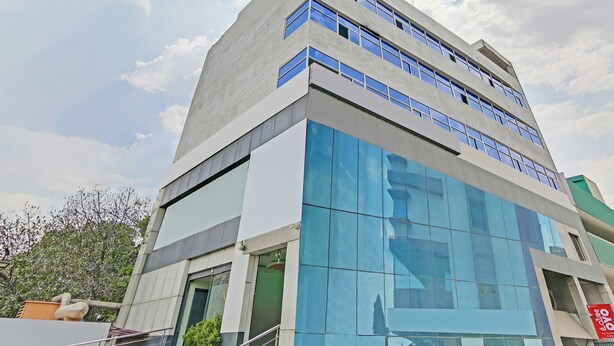 A modern building with multiple floors, large windows, and a flat roof. - OYO Flagship 29620 New Champion Residency (Bengaluru)