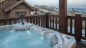 A hot tub on a wooden deck with a mountain view. - Moonlight Basin | Ski-In/ Out | Hot Tub (Big Sky)