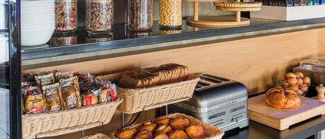 A breakfast buffet with various food items and a toaster.