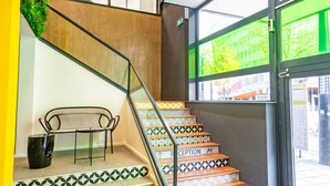 Una escalera con un cartel que dice 'WELCOME', peldaños decorados y un banco.
