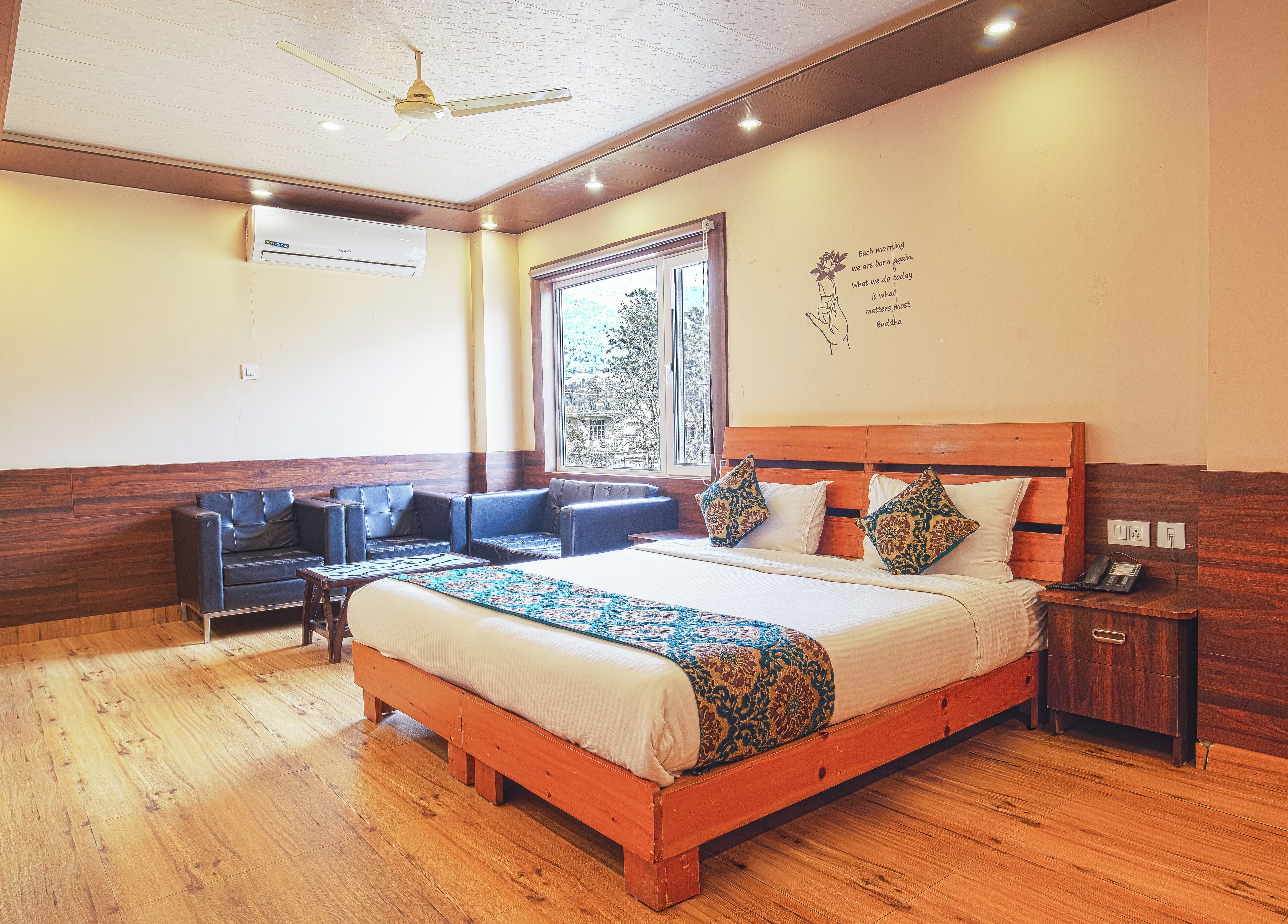 A bedroom with a wooden bed, a sofa, a small table, and a nightstand.