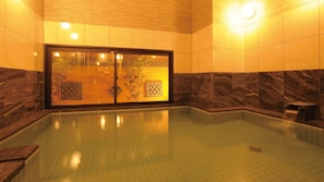 A spa pool with a glass door, tiled walls, and a marble design. - AB Hotel Tokai Otagawa (Tokai)