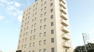 A multi-story hotel building with a prominent 'AB HOTEL' sign on the top.