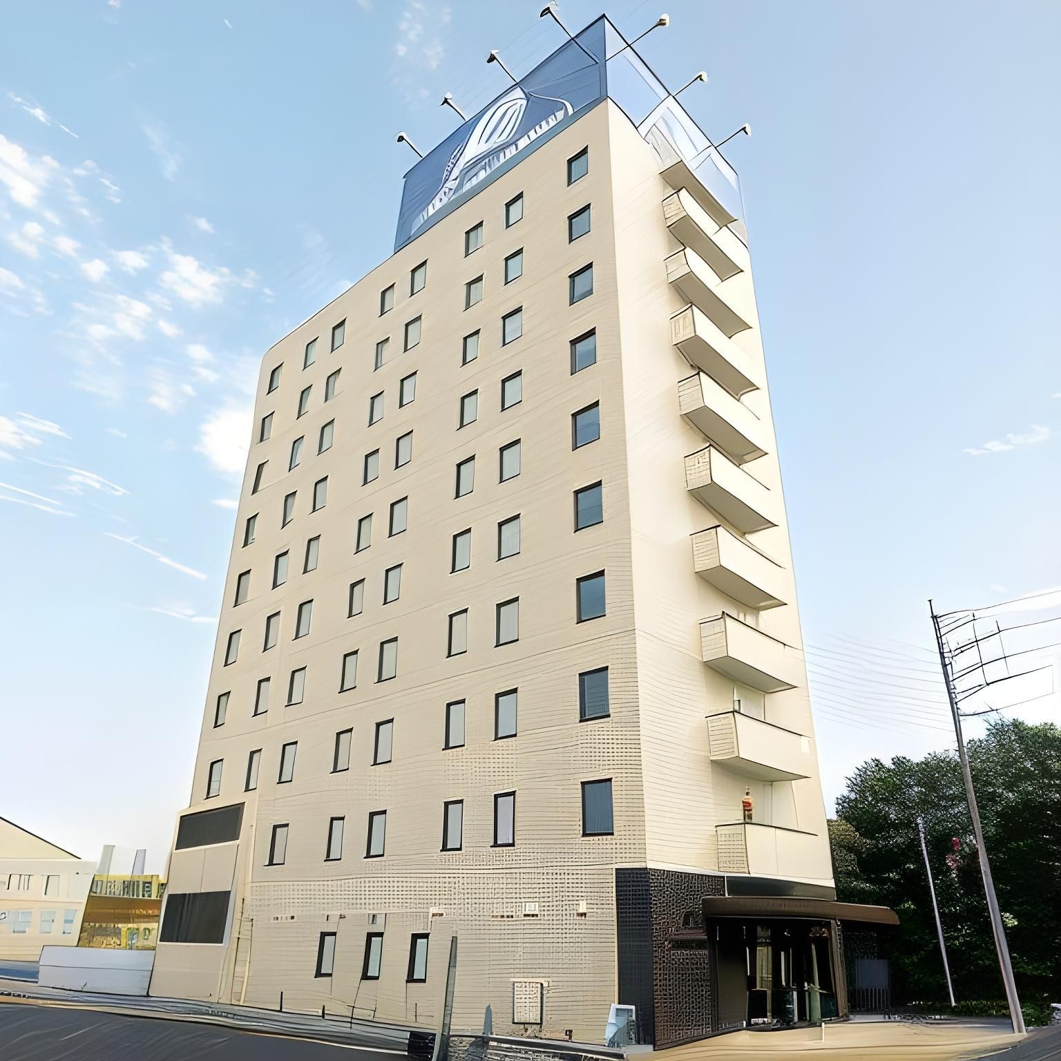 A multi-story hotel with a prominent sign on the top.