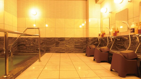 A public restroom with marble walls, a tiled floor, a metal handrail, and multiple sinks with soap dispensers. - AB Hotel Tokai Otagawa (Tokai)
