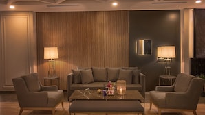 A modern living room with a sofa set, two armchairs, a coffee table, and two floor lamps. - Gumushan Hotel (Korkuteli)