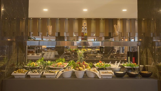 A buffet with various food items and utensils. - Gumushan Hotel (Korkuteli)