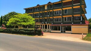 A multi-story building with a sign indicating it is a gift guest house. - Diani Gift Guest House (Diani Beach)