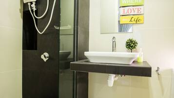 A modern bathroom with a glass-enclosed shower, a sink with a mirror, and a sign that reads "WHERE LOVE THEN LIFE".