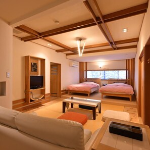 A modern hotel room with a sofa, two beds, a TV, and a window with a view. - Ikaho Onsen Akari No Yado Okabe (Shibukawa)