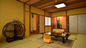 A traditional Japanese room with tatami flooring, a low table, a wooden chair, and a decorative shelf. - Ikaho Onsen Akari No Yado Okabe (Shibukawa)
