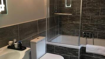 Shower, designer toiletries, hair dryer, bathrobes