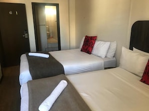 A hotel room with two beds, a door labeled '61', and a bathroom visible through an open door. - Businessburg Hotel (Johannesburg)