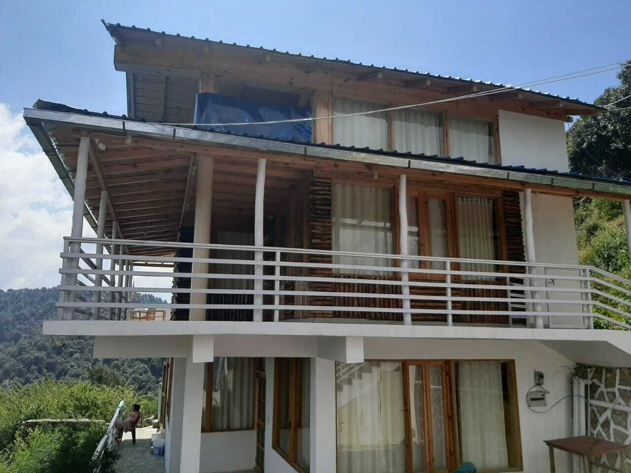 A two-story building with a balcony and a wooden facade.