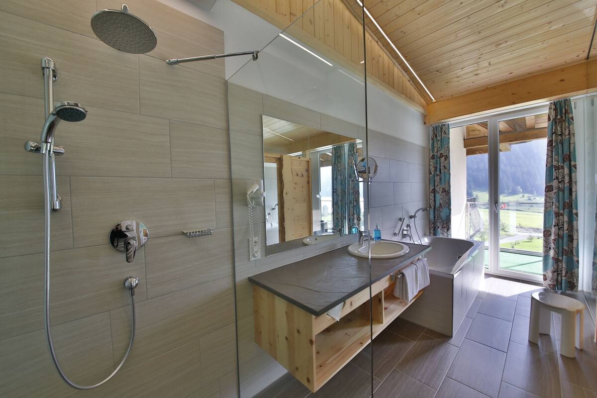 junior suite, lake view | bathroom | bathrobes, towels