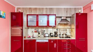 A modern kitchen with red cabinets, a microwave, a toaster, and a coffee maker. - Exclusive 3 bedrooms split level sea-views apartment overlooking Bigova Bay (Bigova)