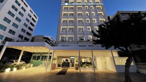 A modern hotel with a prominent sign reading "ATHENAUM SMART HOTEL". - Athenaeum Smart Hotel (Athens)