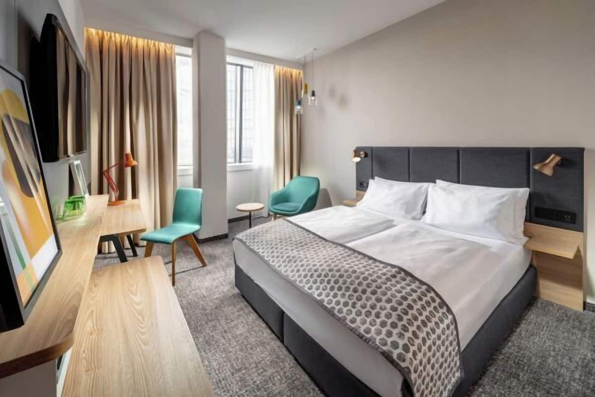 Premium bedding, desk, laptop workspace, blackout curtains