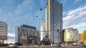 A modern building with a curved glass facade, a prominent entrance with a canopy, and a visible sign for 'IMMOFINANZ'. - Clarion Hotel Vienna South (Vienna)