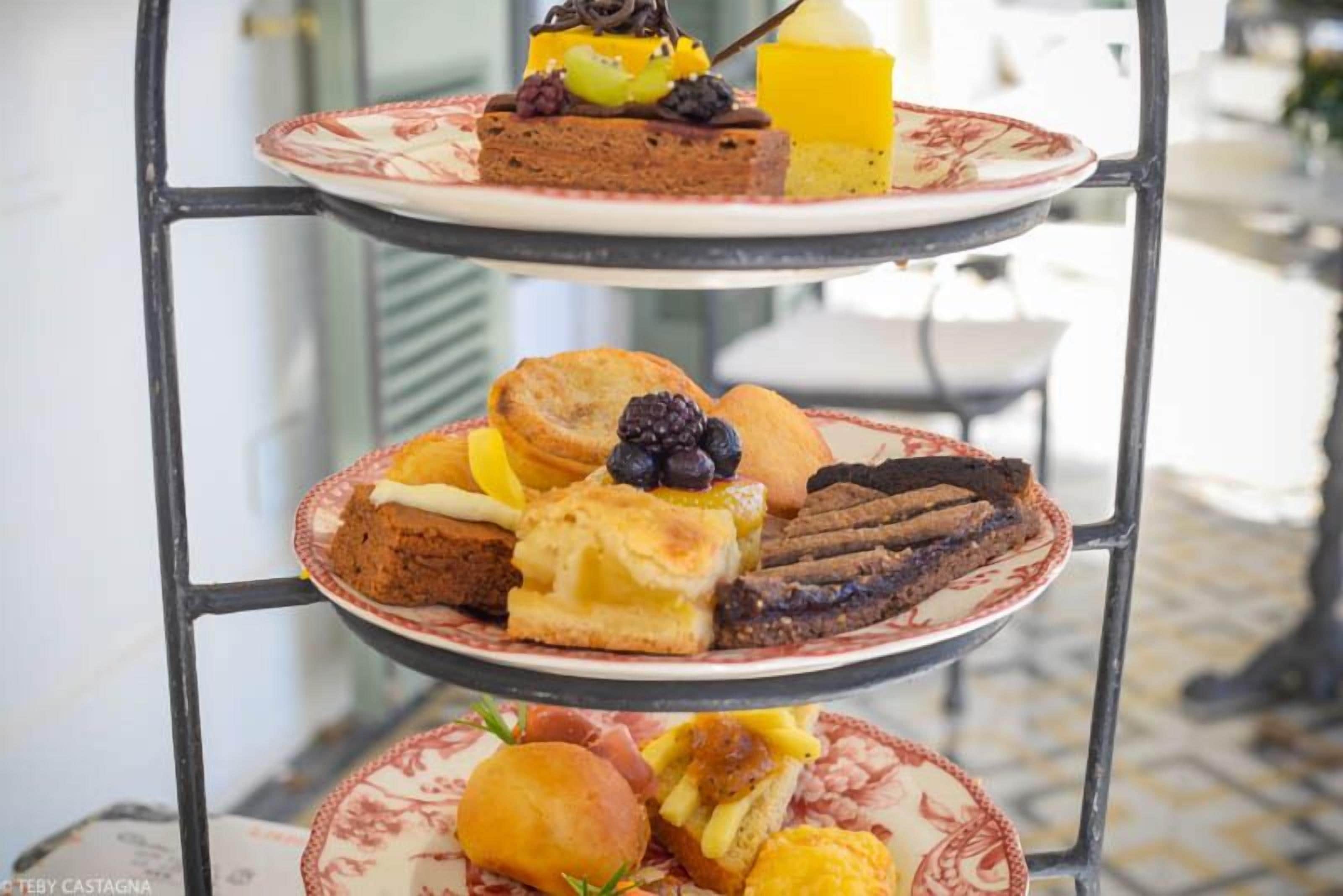 A three-tiered dessert stand with various pastries and desserts.