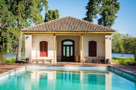 Seasonal outdoor pool, open 9:00 AM to 7:30 PM, pool umbrellas. Estancia La Paz Hotel