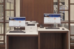 Two desktop computers on a desk with a printer, a keyboard, and a mouse. - Holiday Inn Express & Suites Downtown Ottawa East by IHG (Ottawa)