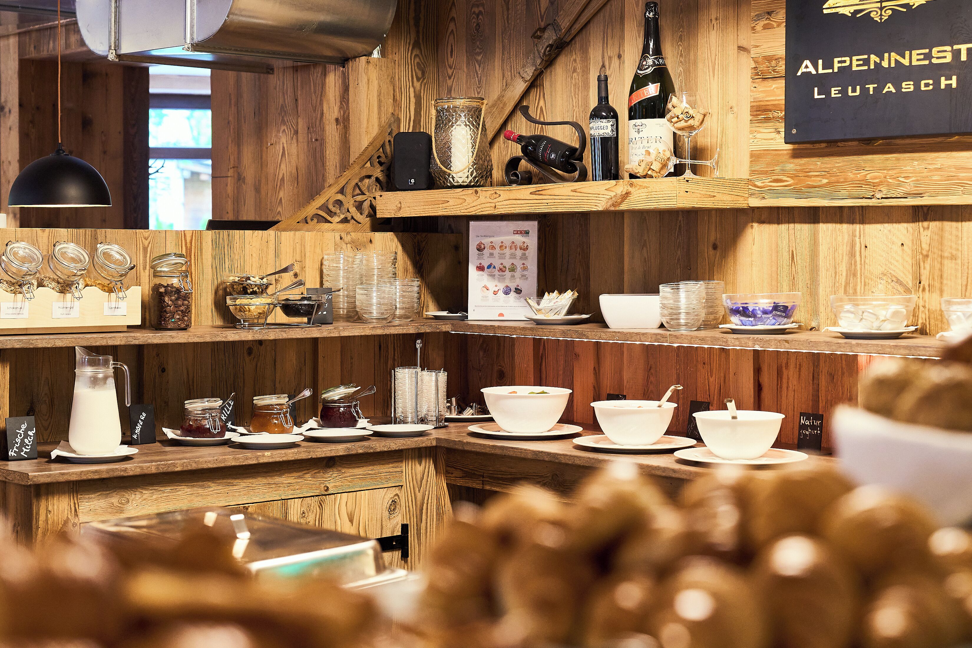 A wooden interior with shelves displaying various jars, bottles, and bowls.